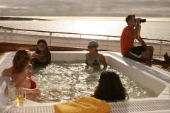 Fun time with friends on the jacuzzi of the Galapagos Yacht Evolution