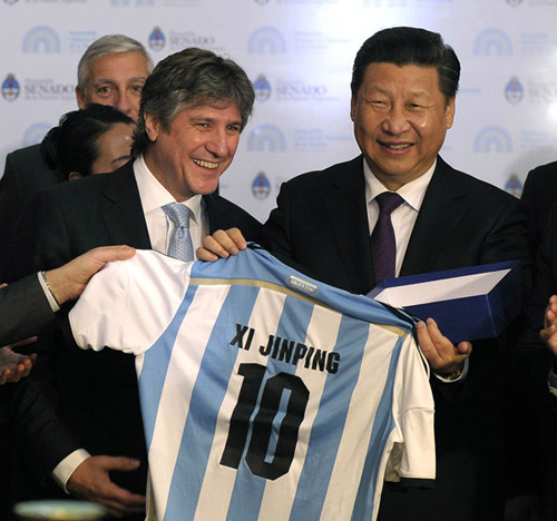 China's President Xi Jinping  receives an Argentine soccer jersey with his name 