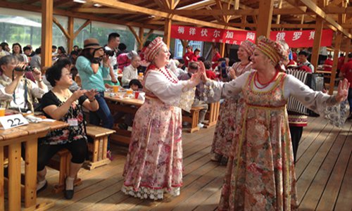 Chinese tourists watch traditional Russian dancing